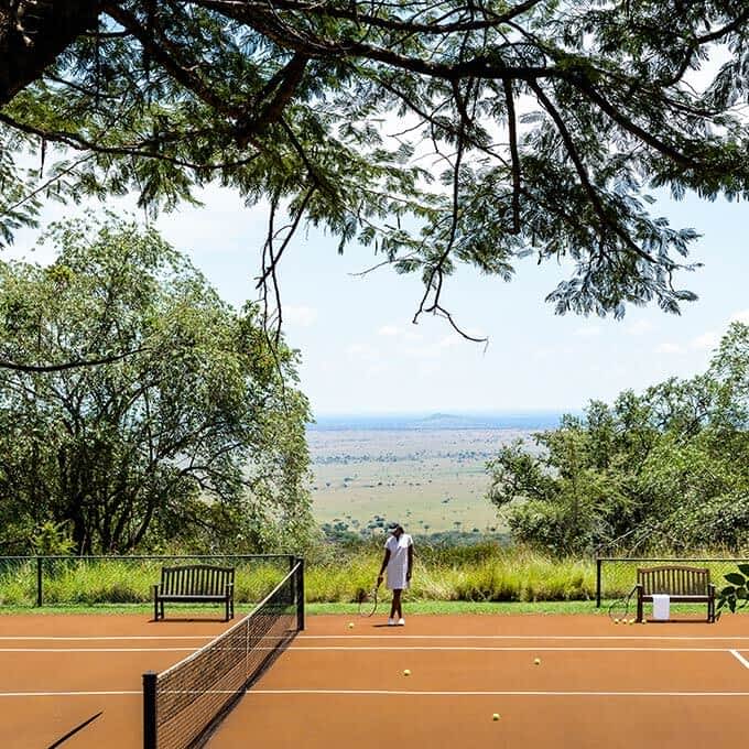 Play tennis in Tanzania during your stay at Singita Sasakwa Lodge in the Serengeti